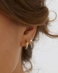 Arms of Eve Jean Huggie Earrings Gold